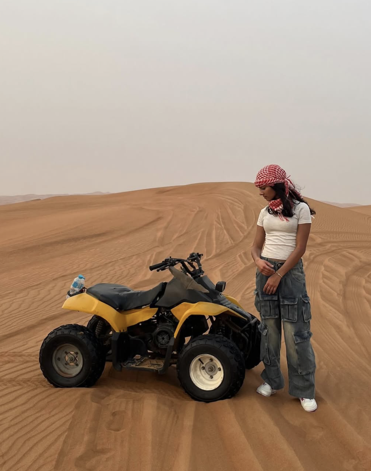Xara in the desert beside a quad bike