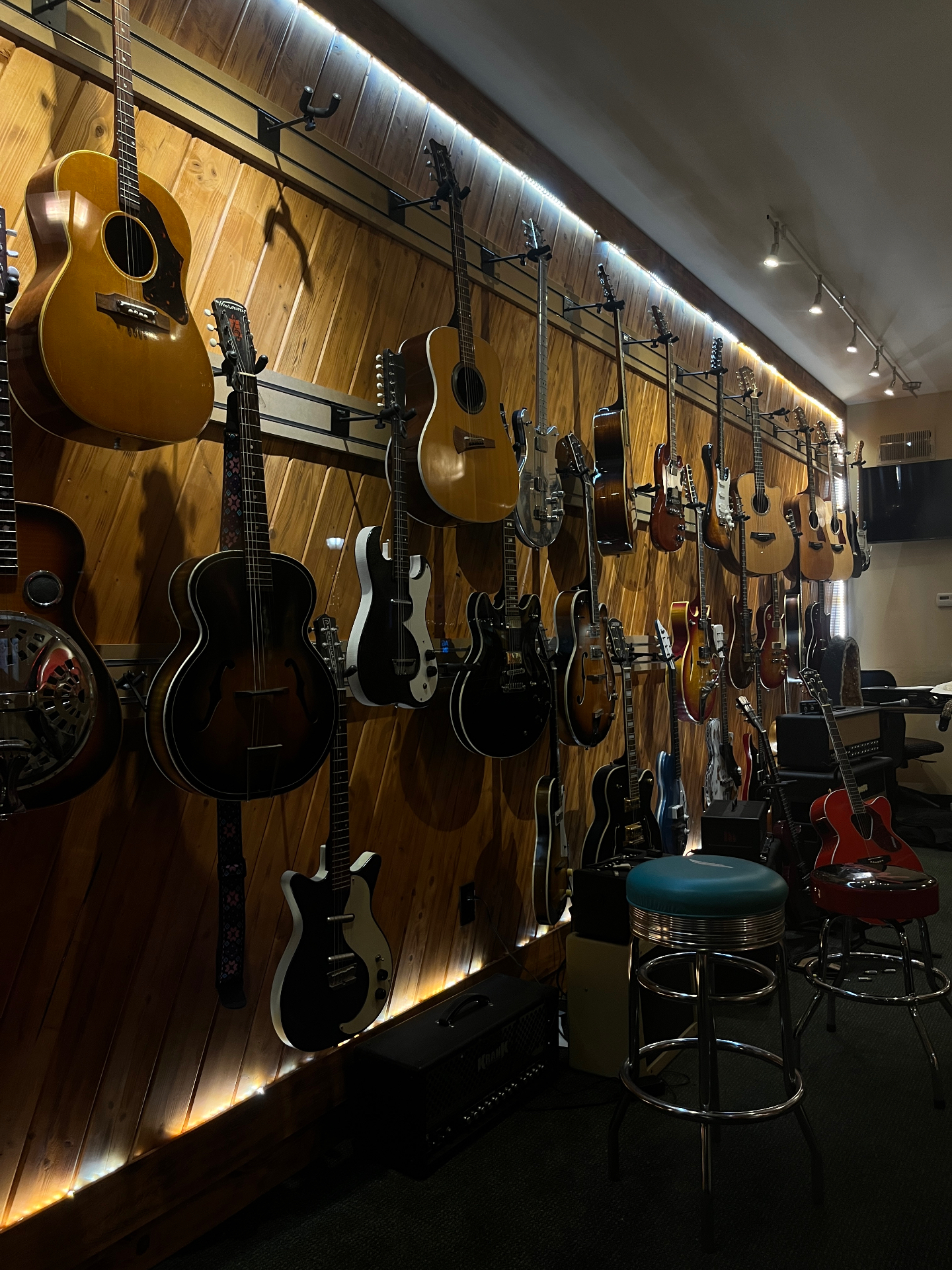 A wall of vintage guitars